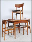 A 1970's retro Danish influenced teak wood dining table and set of 4 butterfly back dining chairs.