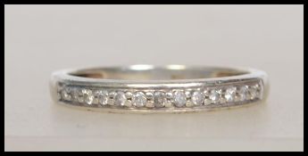 A diamond half hoop eternity ring in 9ct white gold setting weighing 2.1g