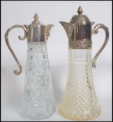 Two vintage early 20th century lead cut glass claret jugs having silver plated tops and lids.
