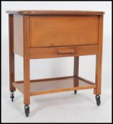 A vintage retro 1950's sewing box in beech wood having hinged top over drawer and raised on