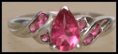 A hallmarked 9ct white gold ring set with pink stones in the Art Nouveau style . Hallmarked