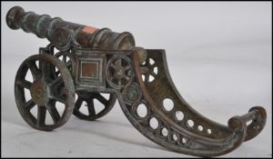 A large 20th century bronze desk top cannon. The decorative large cannon raised on a shaped cannon