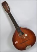 A vintage early 20th century 8 string mandolin guitar having a shaped body and inlaid bone fret