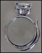A decorative contemporary silver magnifying glass of circular form having mount in the form of a