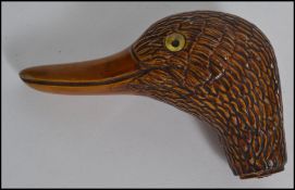 A vintage 20th century black forest style walking stick top / handle in the form of a duck being