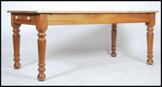 A large Victorian twin drawers pine and beech farmhouse dining table of large form. The table raised