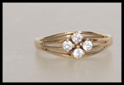 A hallmarked 9ct gold ring  set with white stones in a pierced gallery . Hallmarked London  . Weight