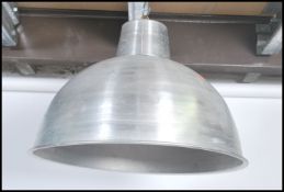 A large 20th century polished aluminium Industrial factory pendant light. The pendant half moon