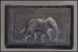 A Siam silver matchbox holder cast in relief with scenes of elephant, plain cartouche to verso.