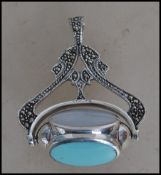 A large silver fob / Art Nouveau necklace pendant with a turquoise  and onyx panel swivel to centre.