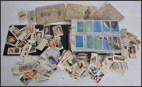 A collection of vintage cigarette cards in album to include Ardarh, Phillips, Wills, Players etc .