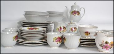 An extensive bone China tea service by Royal Norfolk in the manner of Royal Albert Country Roses,