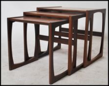 A vintage retro 1970's G-Plan retro teak wood nest of tables raised on shaped supports with
