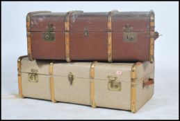 Two early 20th century wooden and canvas bound steamer trunks having clasps to front and hinged