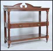 A 19th century Victorian mahogany 3 tier buffet sideboard. Raised on brown ceramic castors with