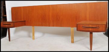 A 1970's retro G-Plan large teak wood headboard in the Kelso pattern having drawers to either side