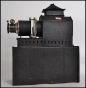 A vintage 20th century magic lantern slide viewer of metal tin construction having an ebonised