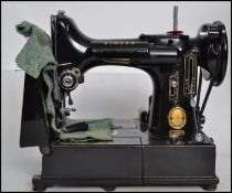 A vintage Singer 222k Featherweight / feather weight folding portable electric Sewing Machine,