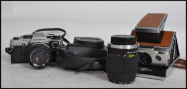 A vintage 20th century Polaroid Land Camera, Olympus 35mm camera and lenses and a Agfa cine