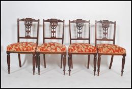 A late Victorian rosewood saloon suite comprising of scroll end chaise longue, gents and ladies