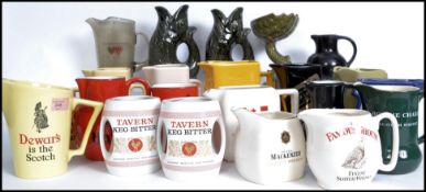 A collection of vintage and retro 20th century ceramic advertising water jugs with jugs having