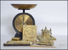 A collection of brass wares to include Victorian desk tidy, pen tray, sundial, salter scales, spirit