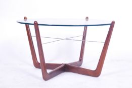 A 1970's Danish teak wood and glass atomic coffee table. The good teak frame with cross stretchers
