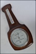A vintage 20th century banjo clock / barometer with thermometer, the silvered barometer dial