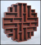 A 20th century hardwood Chinese wall bookcase. Of multiple sections having chamfered edge