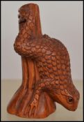 A carved Chinese / Japanese wooden netsuke in the form of a a frog on a tree. Measures 4.5cms high /