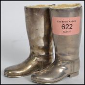 A pair of vintage 20th century silver plated drinks measures in the form of riding boots having