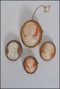 A group of four shell cameo brooches to include three silver white metal mounted examples and one