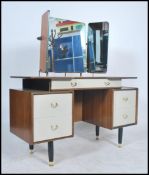 A 1960's retro G-Plan Chinese white and tola wood dressing table having triple mirrors over a