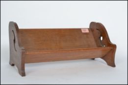 A 1930's Arts and Craft oak book trough of usual f