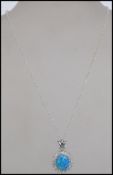 A large silver cluster cz and opal pendant and necklace chain, complete in the presentation box.