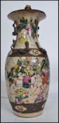 A large 20th century Chinese famille rose baluster vase being converted to a table lamp. The vase