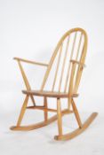 An Ercol 20th century blond wood retro rocking chair in the windsor pattern. Sleigh runners with
