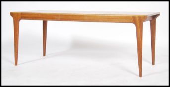 A good Danish 1970's retro rectangular coffee table raised on rounded edge tapering legs with good