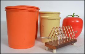 A group of retro mid 20th century items to include 4 1960s Tupperware storage containers in orange
