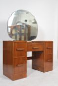A 1930's Art Deco walnut drop centre dressing table. Raised on twin pedestals, each with drawers