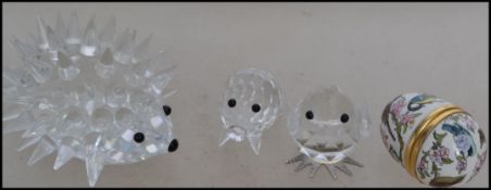A group of small studio glass Swarovski crystal animals along with a enamel egg by Halcyon Days.