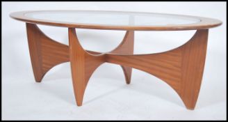 A retro 20th century vintage teak wood atomic oval coffee table by G Plan, having a drop centre