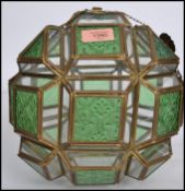 An Edwardian green glass and clear glass Arts & Crafts porch lantern. Brass tubelined edges with