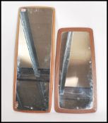 Two vintage 20th century retro teak wall mirrors of oblong form, one being a frame less mirror
