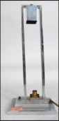 An Art Deco chrome table / desk lamp standing on a square base supporting a rectangular frame.