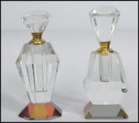 Two early 20th century faceted glass perfume bottles, both complete with original stoppers having