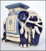 A large elephant ceramic plant stand in white and blue with plinth top dating to the 20th century