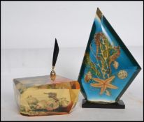 A vintage retro 20th century Dunhill inspired  acrylic Lucite paperweight encasing an arangment of