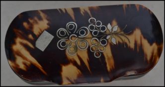 A 19th century gentleman's tortoiseshell and silver inlaid snuff box of lozenge shaped form with