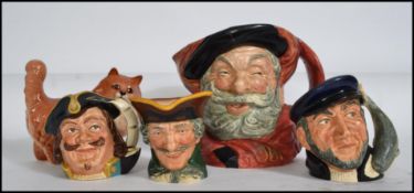 A collection of ceramics to include a Beswick cat, Doulton character jugs to include Falstaff,